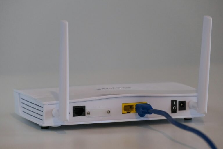 Weißer Router mit eingestecktem Ethernet-Kabel